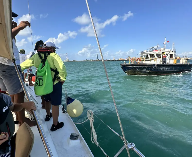 A group of people on a boat in the ocean.