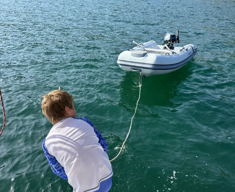 A person in the water with a boat.