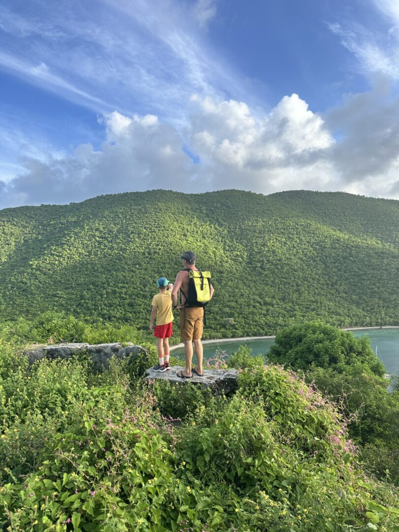 Two people standing on a bridge over water.